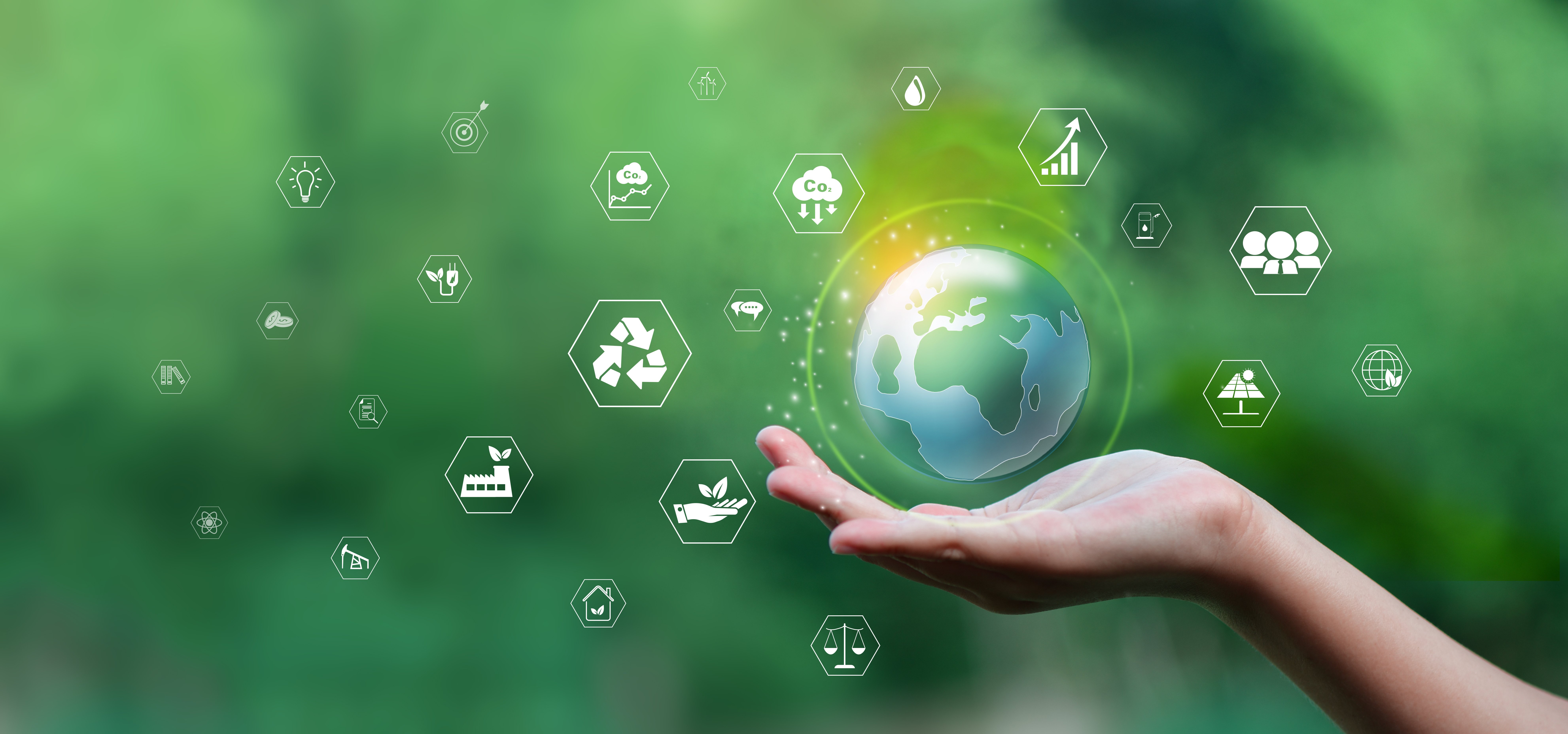 A hand held out holding a globe against a green background with various symbols, including the recycle symbol, a symbol indicating global business and more.